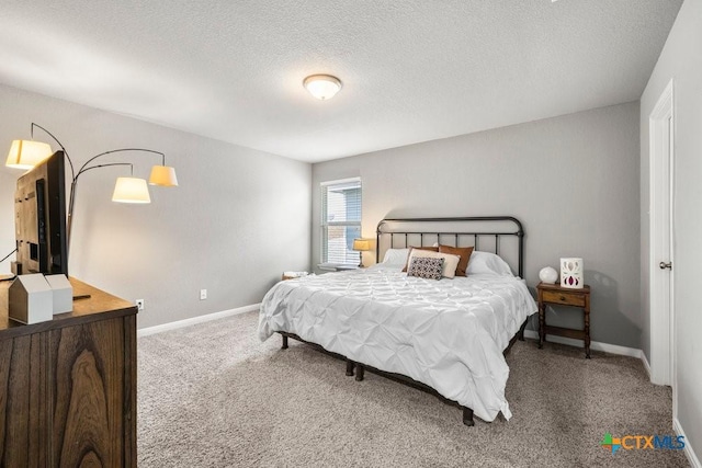 carpeted bedroom featuring a textured ceiling