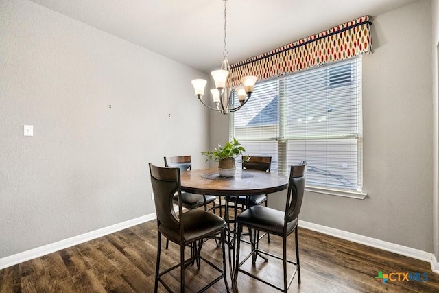 dining area featuring a chandelier and dark hardwood / wood-style floors