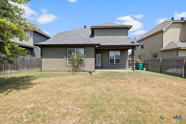 rear view of property with a patio area and a yard