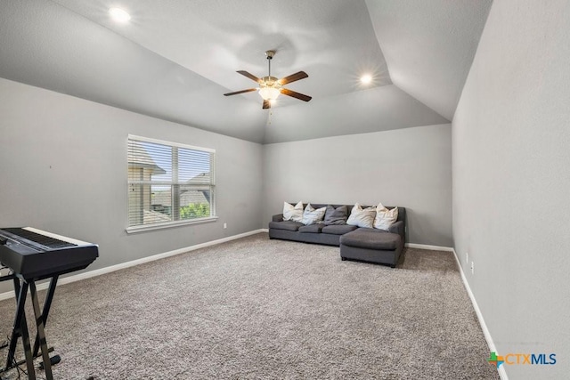 living area featuring ceiling fan, carpet, and vaulted ceiling