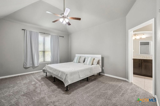 bedroom with connected bathroom, ceiling fan, light colored carpet, and vaulted ceiling