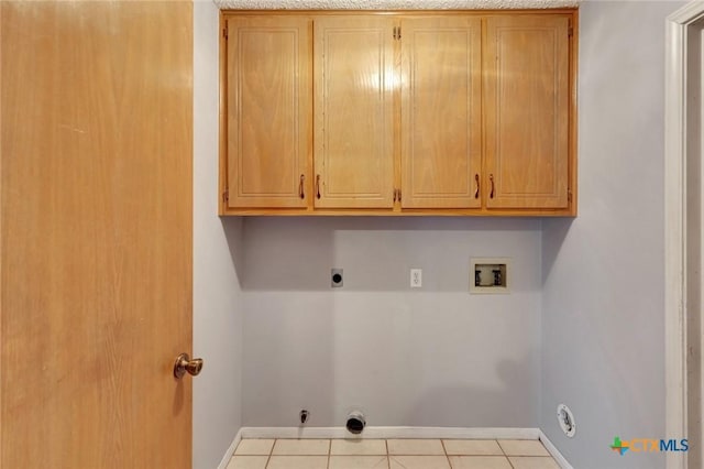 106 Hamlet Ct, Victoria, TX 77901 - laundry area featuring gas dryer hookup, washer hookup, electric dryer hookup, cabinet space, and tile patterned floors