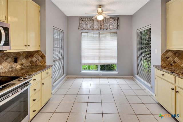 106 Hamlet Ct, Victoria, TX 77901 - kitchen featuring cream cabinetry, white electric stove, and a ceiling fan