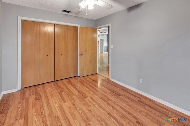 106 Hamlet Ct, Victoria, TX 77901 - unfurnished bedroom with a textured ceiling, light wood-type flooring, a closet, and ceiling fan
