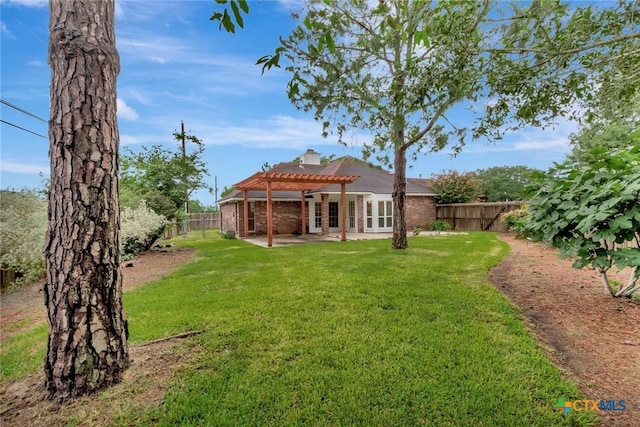 106 Hamlet Ct, Victoria, TX 77901 - back of property featuring a pergola, a fenced backyard, a patio area, brick siding, and a chimney