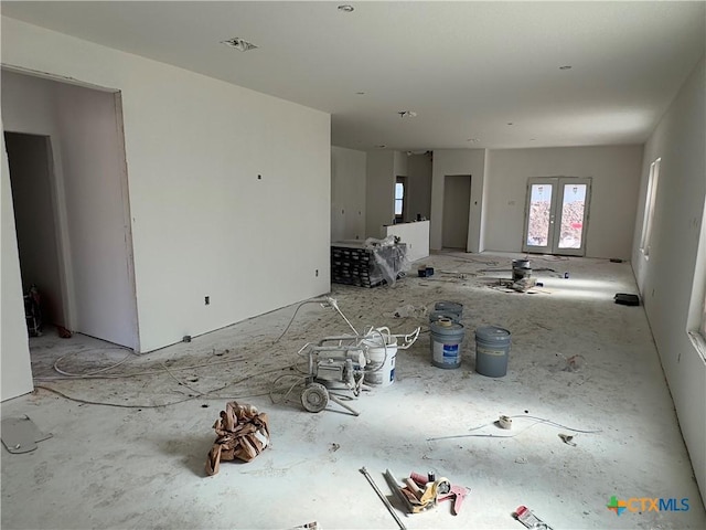 unfurnished living room with french doors