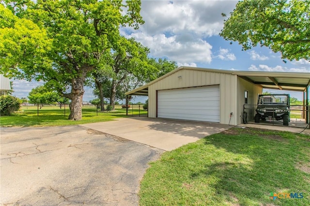 garage with fence and a detached garage