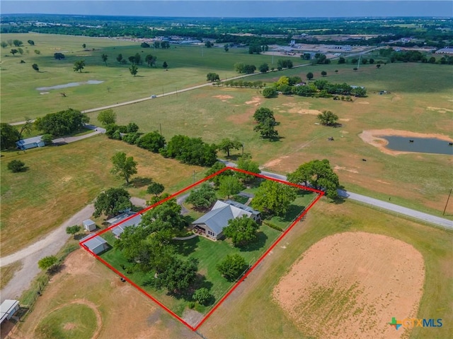 birds eye view of property with a water view and a rural view