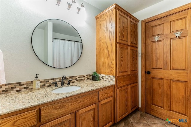 full bathroom with vanity, tasteful backsplash, and tile patterned floors