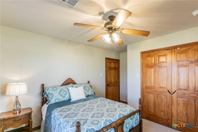 bedroom featuring a ceiling fan, light colored carpet, and visible vents