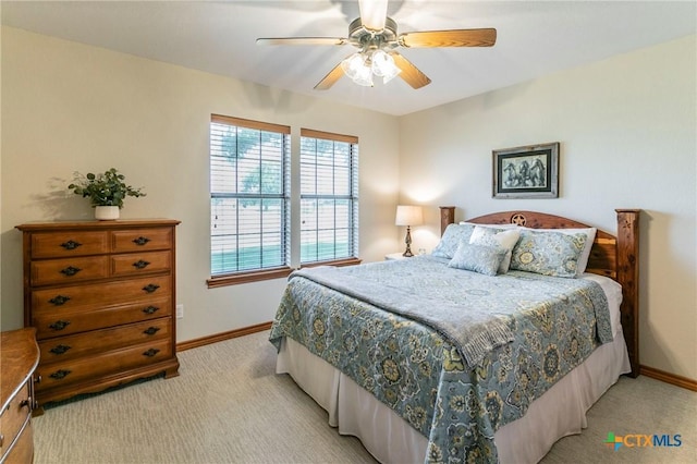 bedroom featuring baseboards, ceiling fan, and light colored carpet