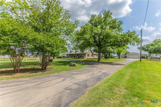 view of front facade with a garage, driveway, and a front lawn