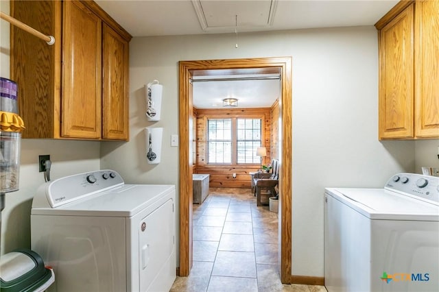 laundry area with washer and dryer, light tile patterned floors, attic access, and cabinet space