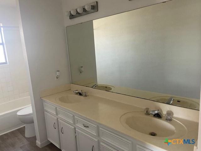 full bathroom featuring toilet, shower / washtub combination, and vanity