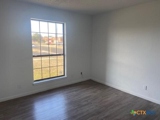 spare room featuring dark hardwood / wood-style flooring