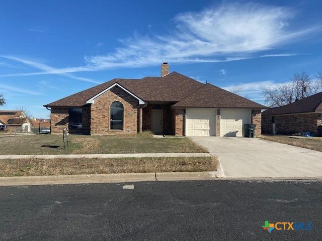 ranch-style house with a front yard and a garage