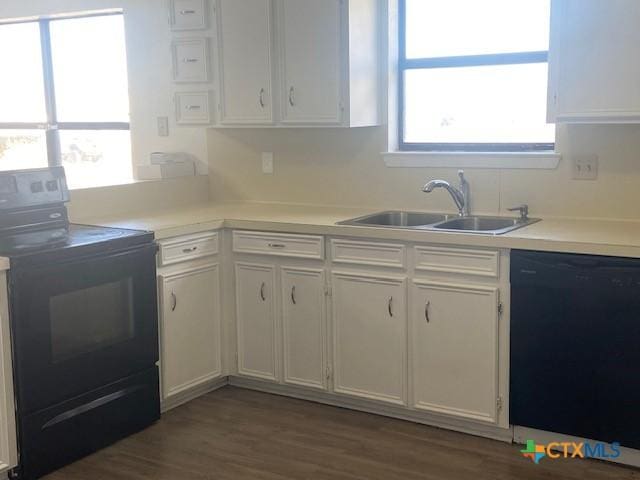 kitchen featuring sink, black appliances, dark hardwood / wood-style flooring, and white cabinetry