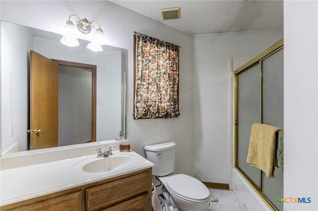 full bathroom with toilet, vanity, tile patterned flooring, and enclosed tub / shower combo