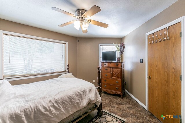 bedroom featuring multiple windows and ceiling fan