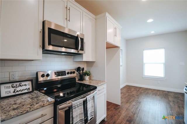 3611 Hanselman Rd, Victoria, TX 77901 - kitchen with stainless steel appliances, tasteful backsplash, white cabinetry, dark wood finished floors, and recessed lighting
