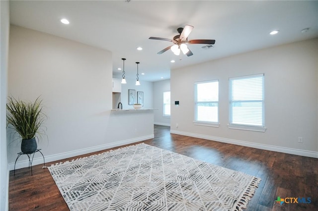 3611 Hanselman Rd, Victoria, TX 77901 - unfurnished living room featuring ceiling fan, baseboards, dark wood-style floors, and recessed lighting