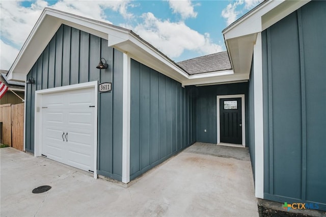 3611 Hanselman Rd, Victoria, TX 77901 - entrance to property with board and batten siding, an attached garage, and roof with shingles