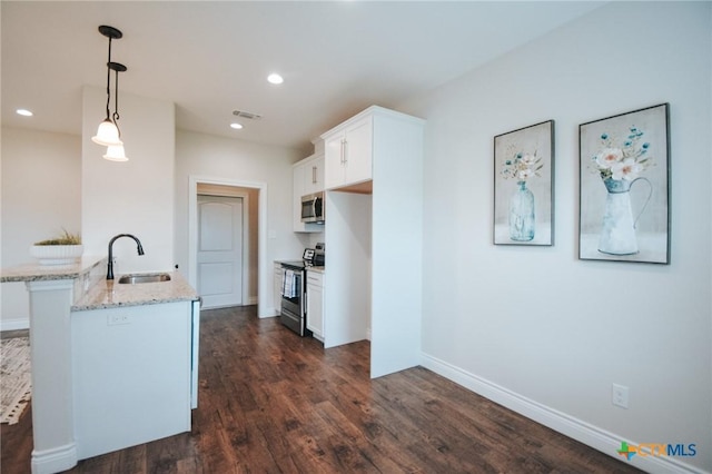 3611 Hanselman Rd, Victoria, TX 77901 - kitchen with a sink, appliances with stainless steel finishes, light stone countertops, white cabinets, and dark wood-style flooring