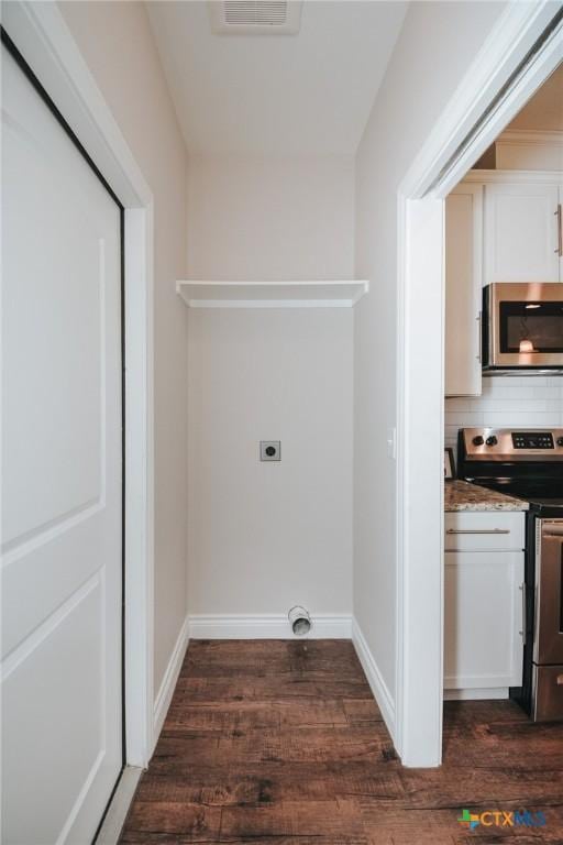 3611 Hanselman Rd, Victoria, TX 77901 - washroom with dark wood-style flooring and baseboards
