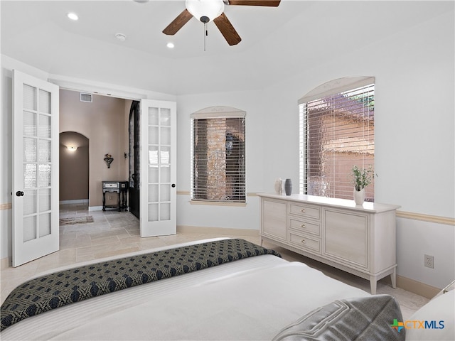 bedroom featuring a raised ceiling and french doors