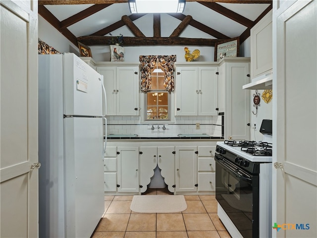 kitchen with gas range, white cabinetry, tasteful backsplash, light tile patterned floors, and white fridge