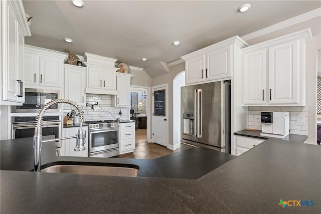 2015 Th Jones Mill Way, Salado, TX 76571 - kitchen featuring stainless steel appliances, dark countertops, crown molding, backsplash, and recessed lighting