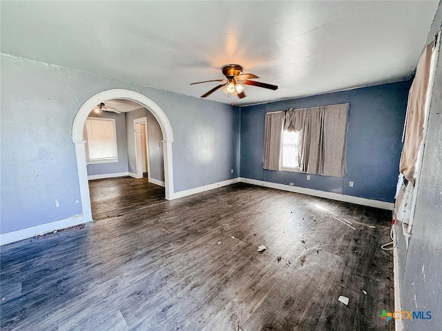 empty room featuring dark hardwood / wood-style flooring and ceiling fan