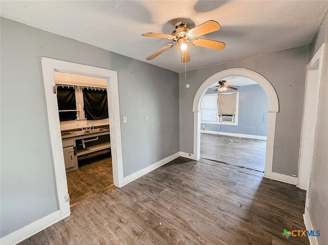 unfurnished room with hardwood / wood-style flooring, ceiling fan, and a textured ceiling