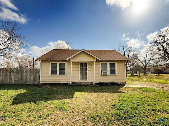 bungalow with cooling unit and a front yard