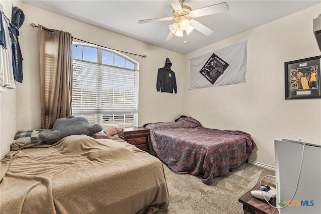 carpeted bedroom featuring baseboards and ceiling fan