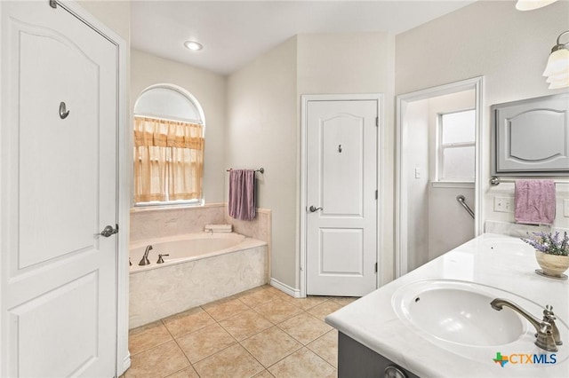 full bath with a sink, a bath, double vanity, and tile patterned flooring