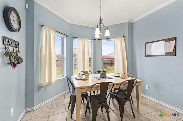 dining room featuring light tile patterned floors, baseboards, and ornamental molding