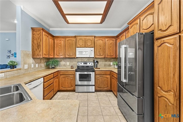 kitchen featuring light tile patterned floors, stainless steel appliances, backsplash, and crown molding