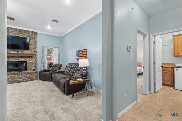 living room featuring visible vents, a brick fireplace, crown molding, light tile patterned floors, and light carpet