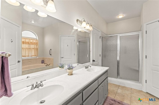 full bath with tile patterned flooring, a shower stall, double vanity, and a sink