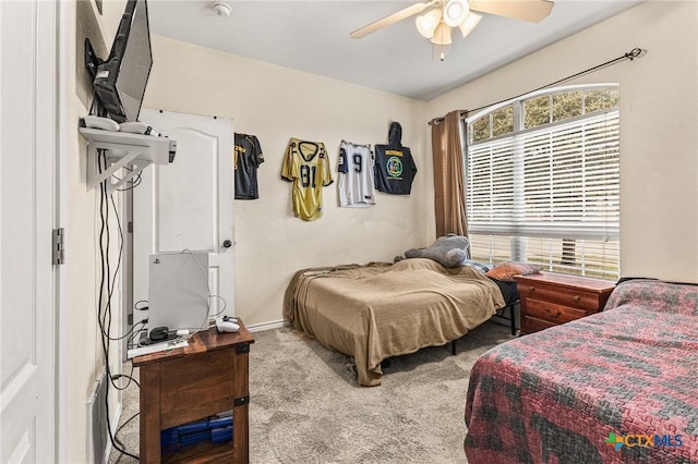 carpeted bedroom featuring baseboards and ceiling fan