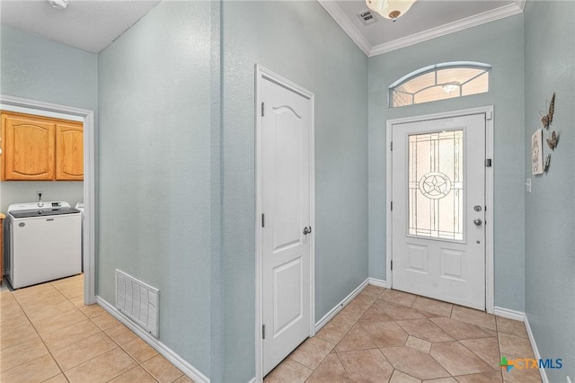 foyer featuring light tile patterned floors, visible vents, crown molding, and baseboards