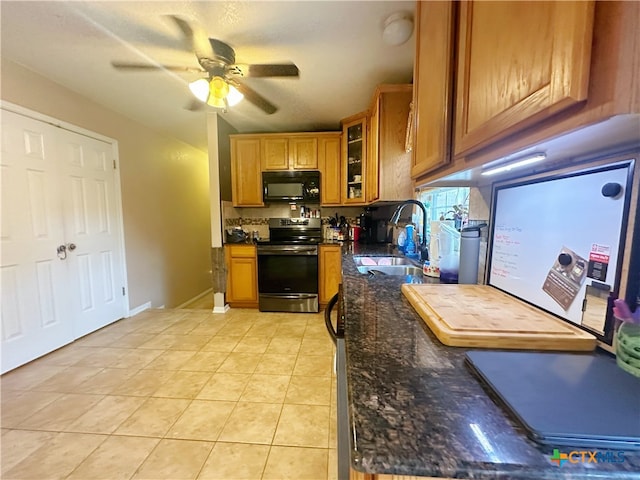 kitchen featuring light tile patterned flooring, dark stone counters, sink, ceiling fan, and stainless steel electric stove