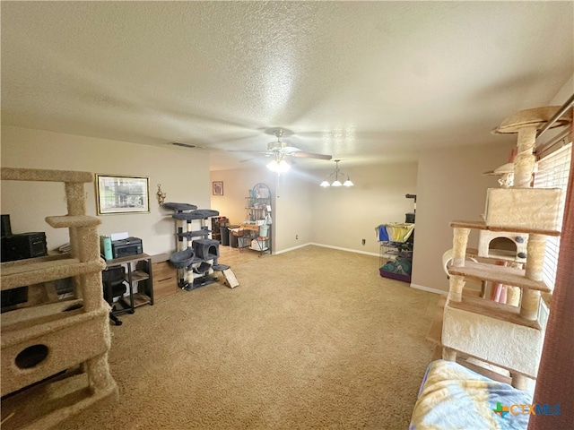 office space featuring carpet, a textured ceiling, and ceiling fan