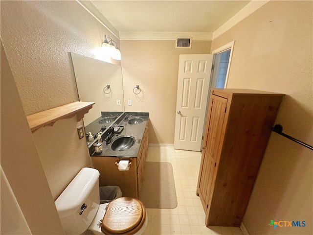 bathroom featuring toilet, vanity, and crown molding