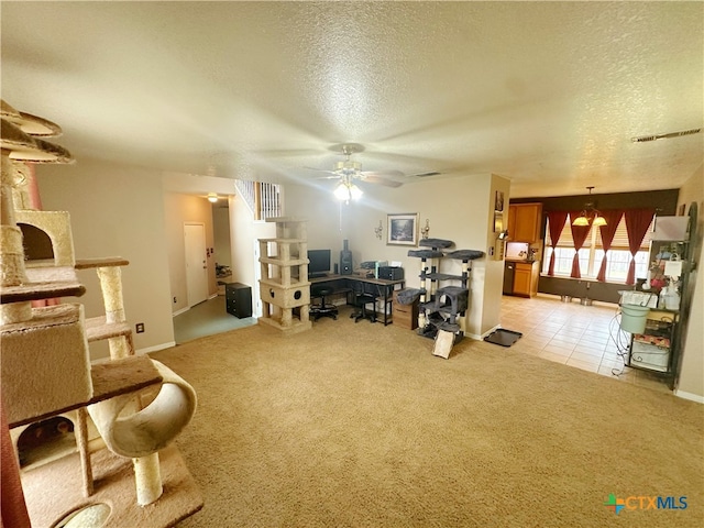 carpeted office space featuring a textured ceiling and ceiling fan