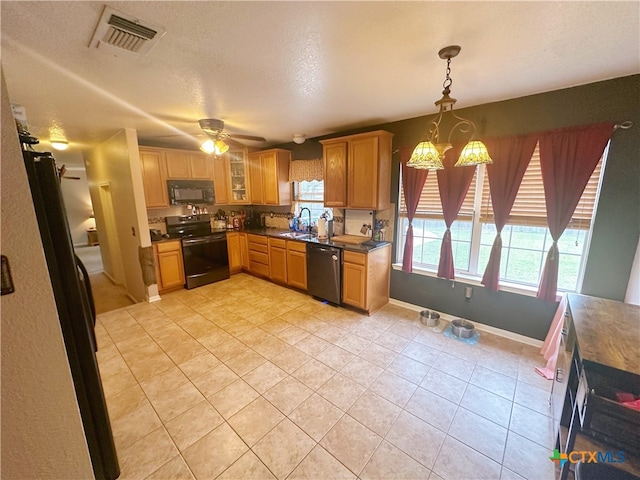 kitchen with black appliances, sink, light tile patterned floors, ceiling fan, and pendant lighting