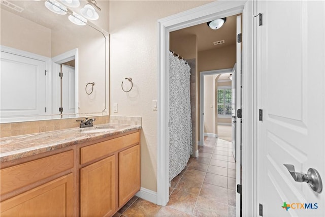 bathroom featuring visible vents, tile patterned floors, and vanity