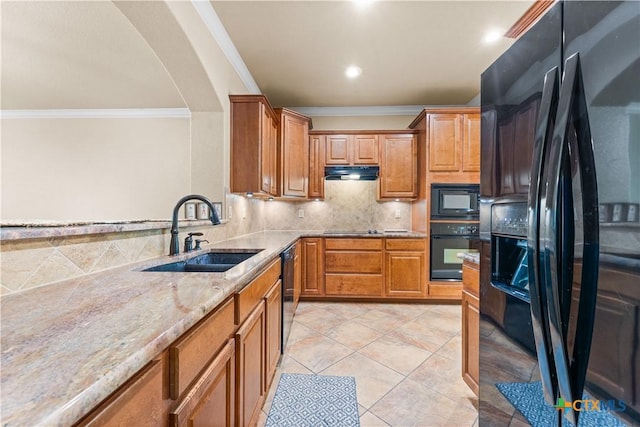 kitchen with exhaust hood, a sink, ornamental molding, black appliances, and light stone counters