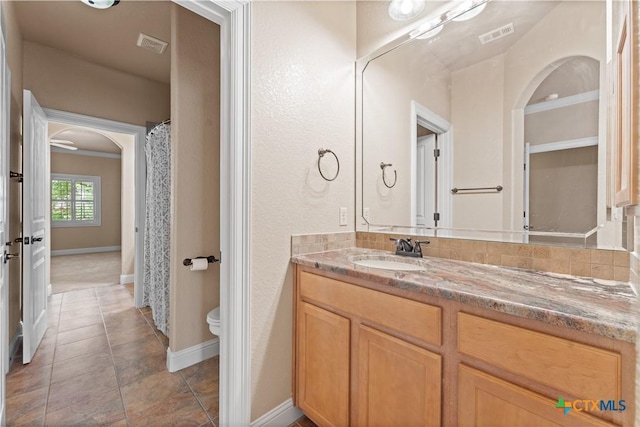 bathroom featuring vanity, visible vents, toilet, tile patterned floors, and baseboards